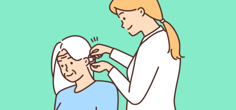 An audiologist or doctor gently fitting a hearing aid onto an elderly woman's ear against a solid green background