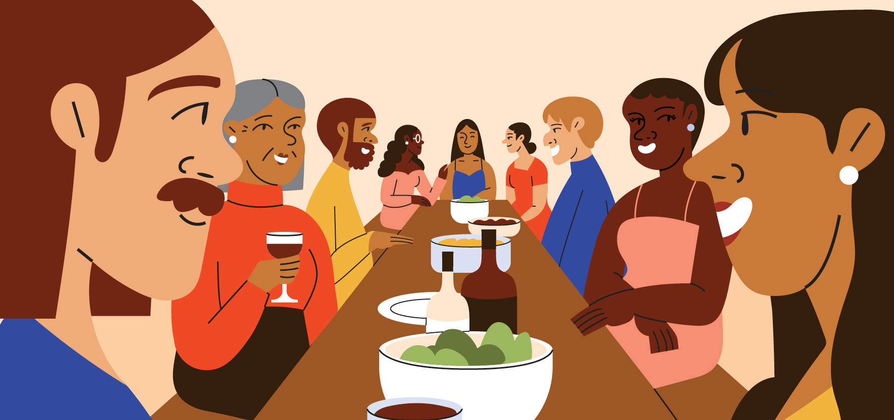 A group of diverse family members and friends gathers around a long table for a holiday dinner