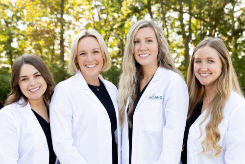 The Hearing Consultants team posing outdoors in matching outfits